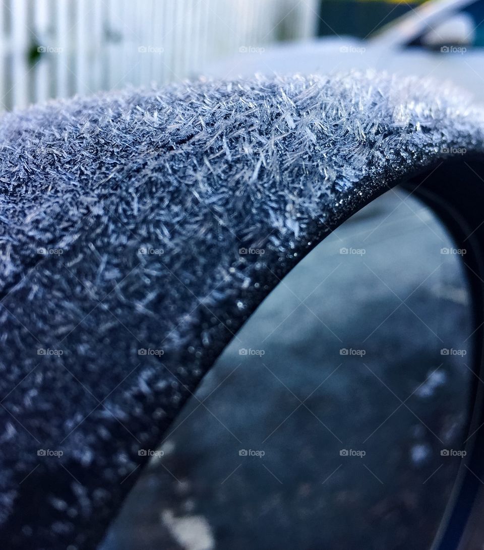 Close-up of frost on car wing mirror