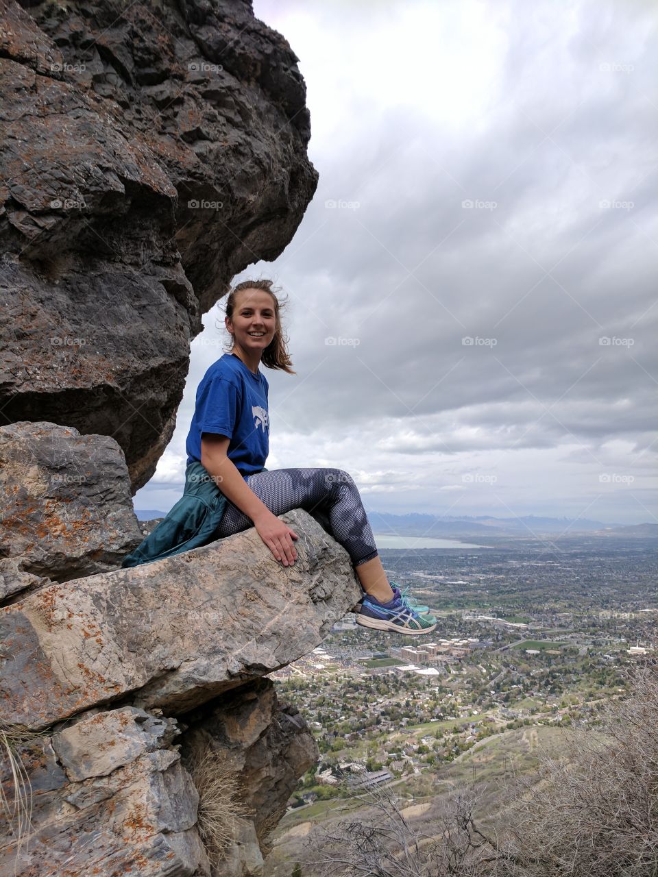 Girl sitting on cliff