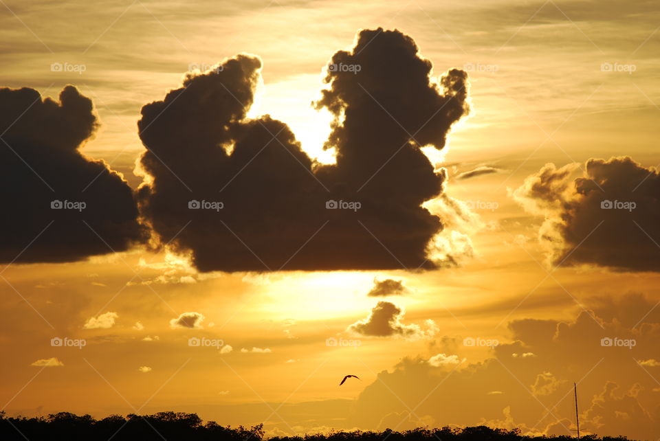 Setting sun hides behind a cloud