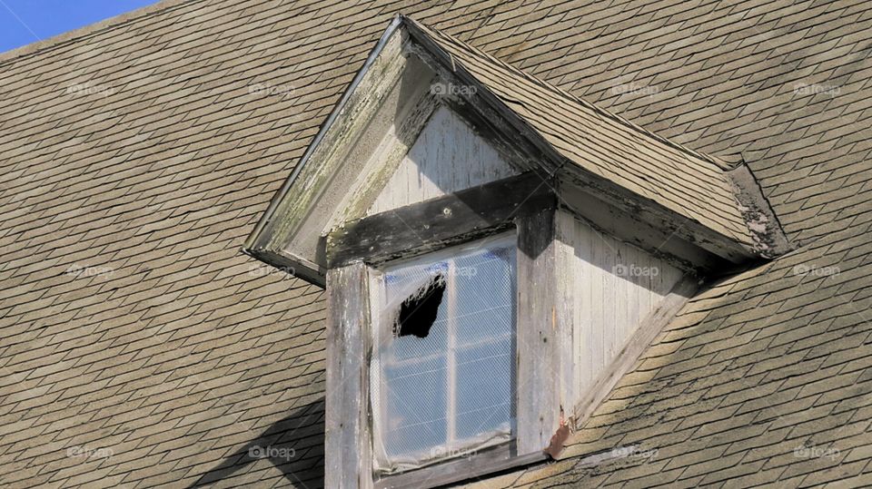 Broken window of abandoned Commons