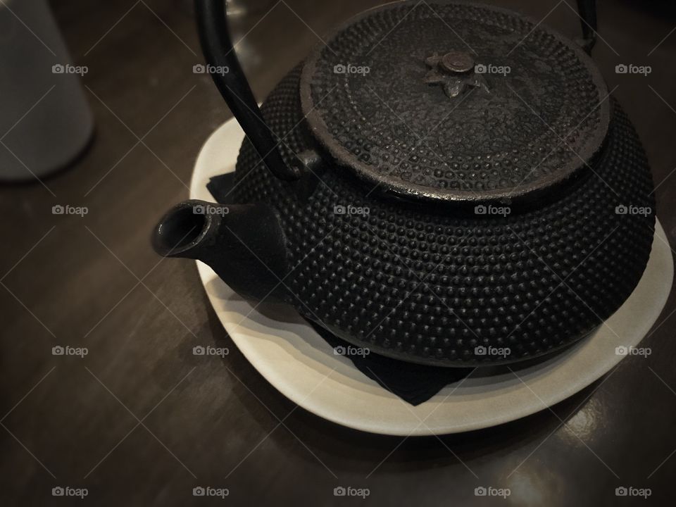 Japanese black teapot on wooden table