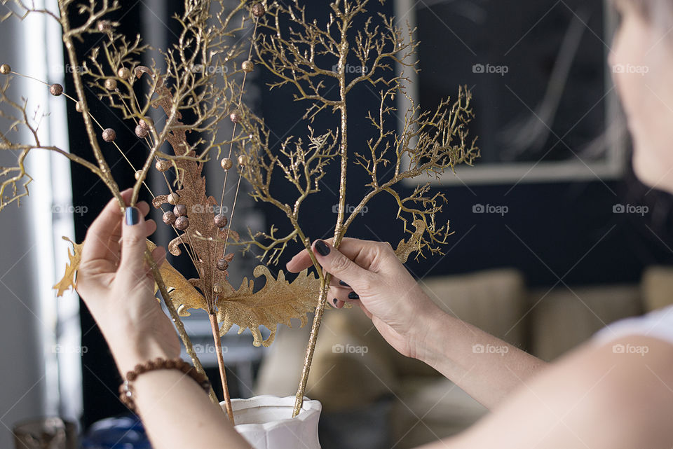 A women holding a artificial plant