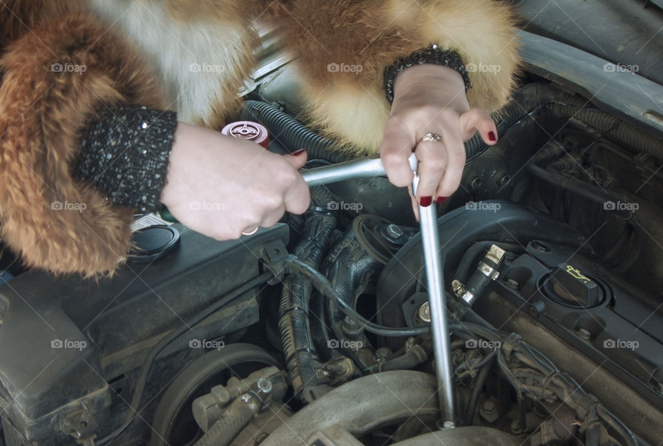 the girl is repairing the car