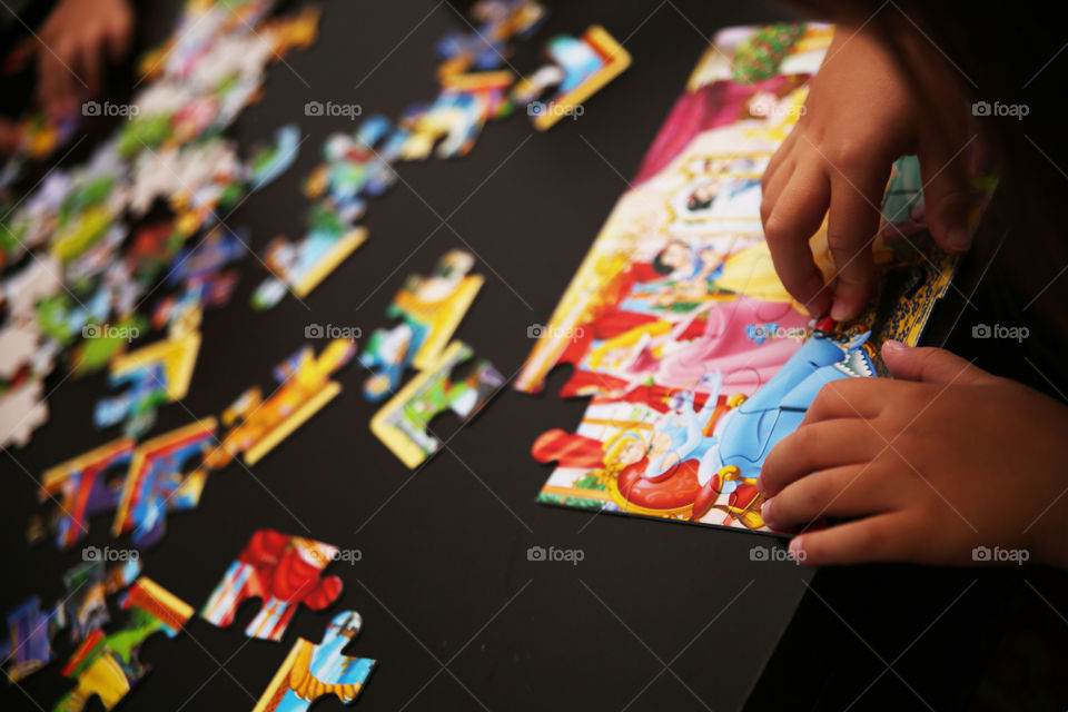 Boy playing with puzzle pieces