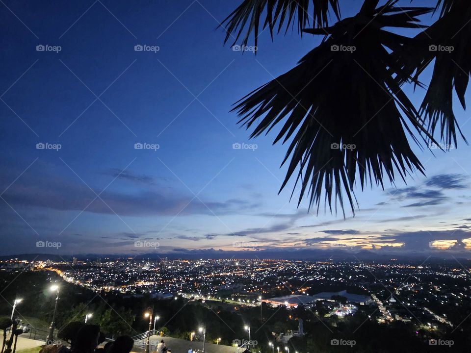 Watching sunset and light of city at night on the top of mountain.