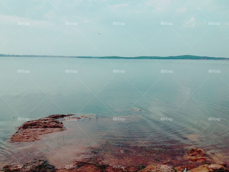 pond side lake with mountain range