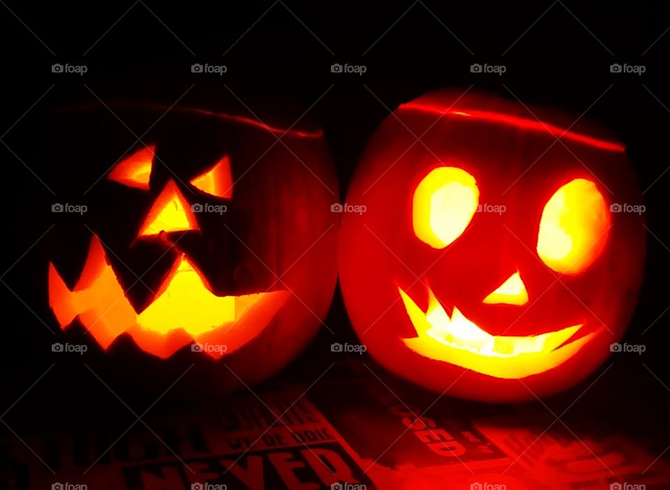 carved pumpkins lanterns glowing in the dark for Halloween