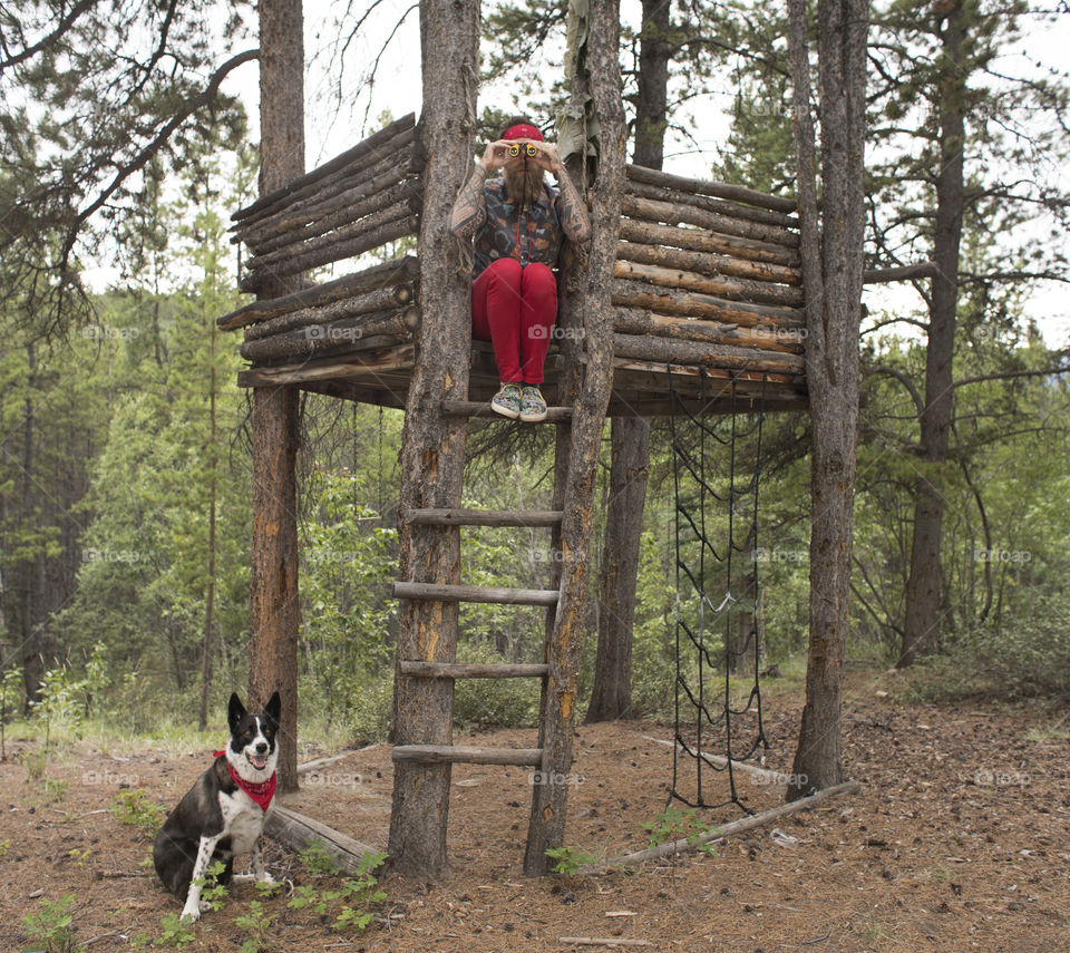 Hipster in Treehouse with Dog