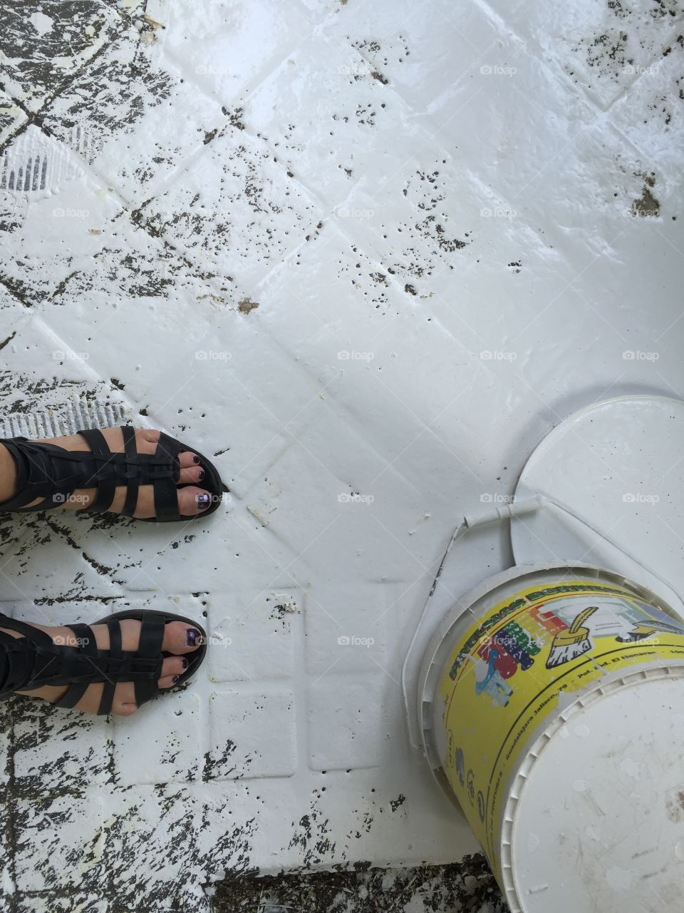 Feet standing in white wasted paint