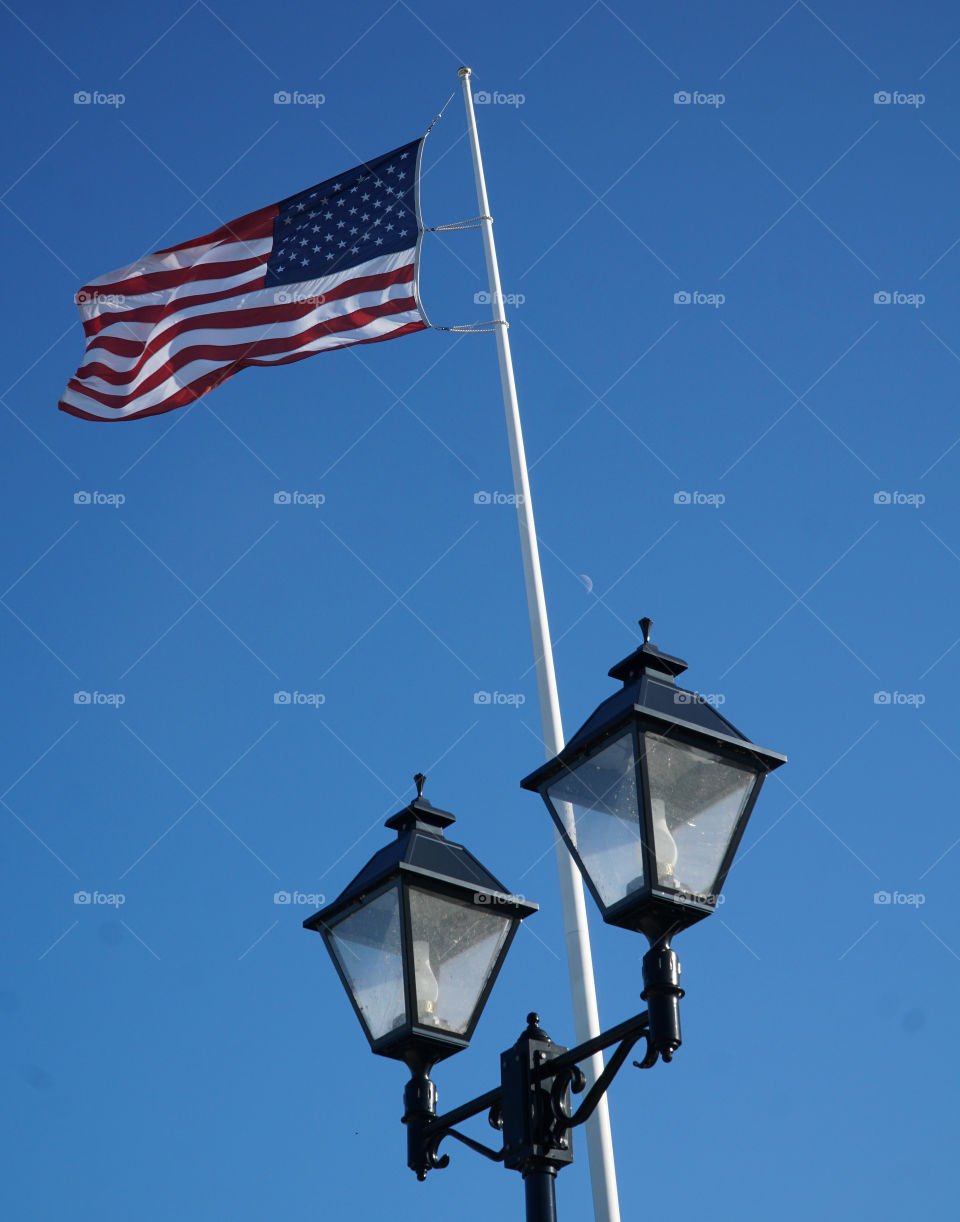 Flag with the moon and lampposts blowing in the wind