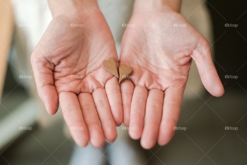 woman hand show mini heart chocolate . De-focused
