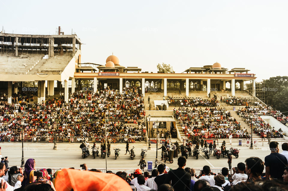 WAGHA BORDER, AMRITSAR, PUNJAB, INDIA - JUNE, 2017. People enjoying the lowering of flags ceremony. Its a daily military practice security forces of India and Pakistan jointly followed since 1959.
