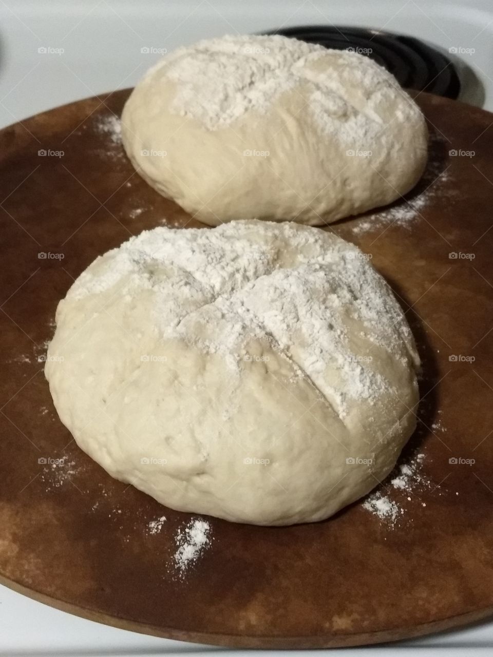 bread dough formed into rustic loaves ready to bake