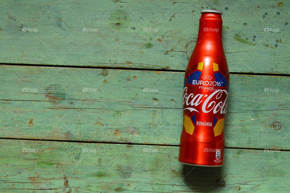 aluminum bottle of Coca cola on a wooden table from euro 2016