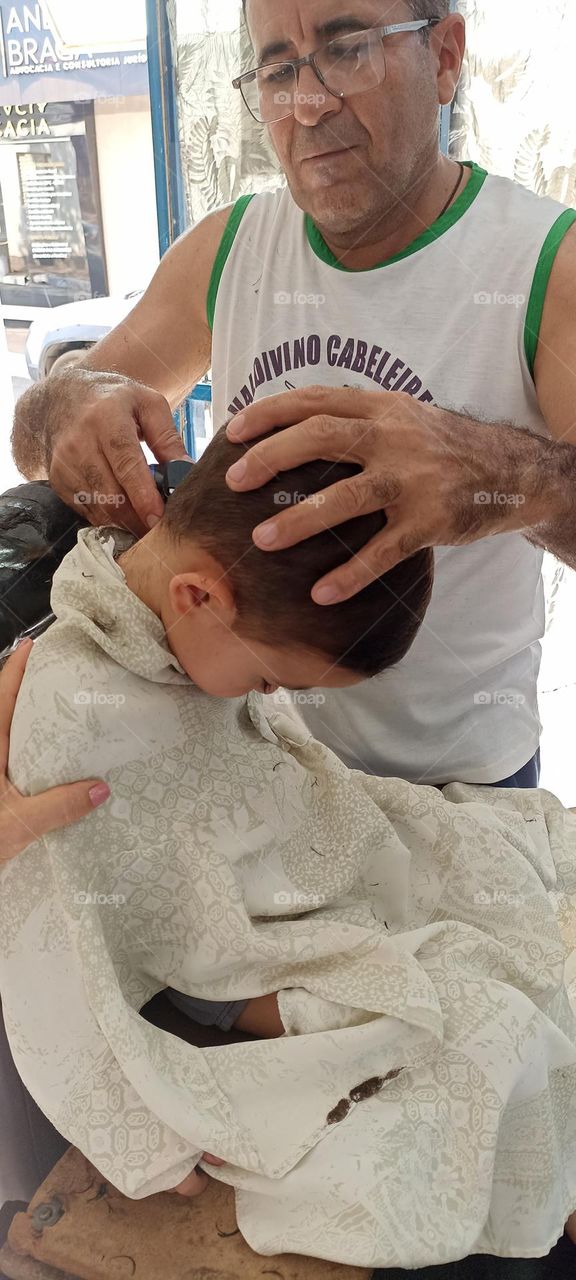 Boy falls asleep while cutting his hair