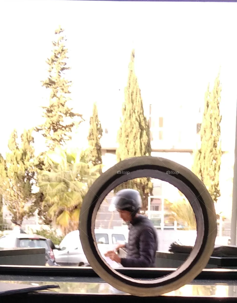 Picture taken from a distance of a person on a motorcycle