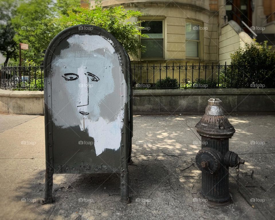 Face drawn on a mailbox on a Brooklyn street corner 