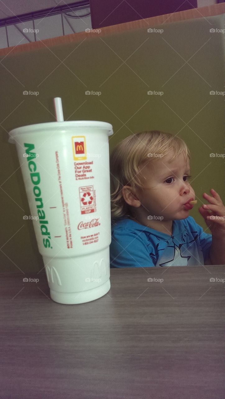 toddler boy eating fries