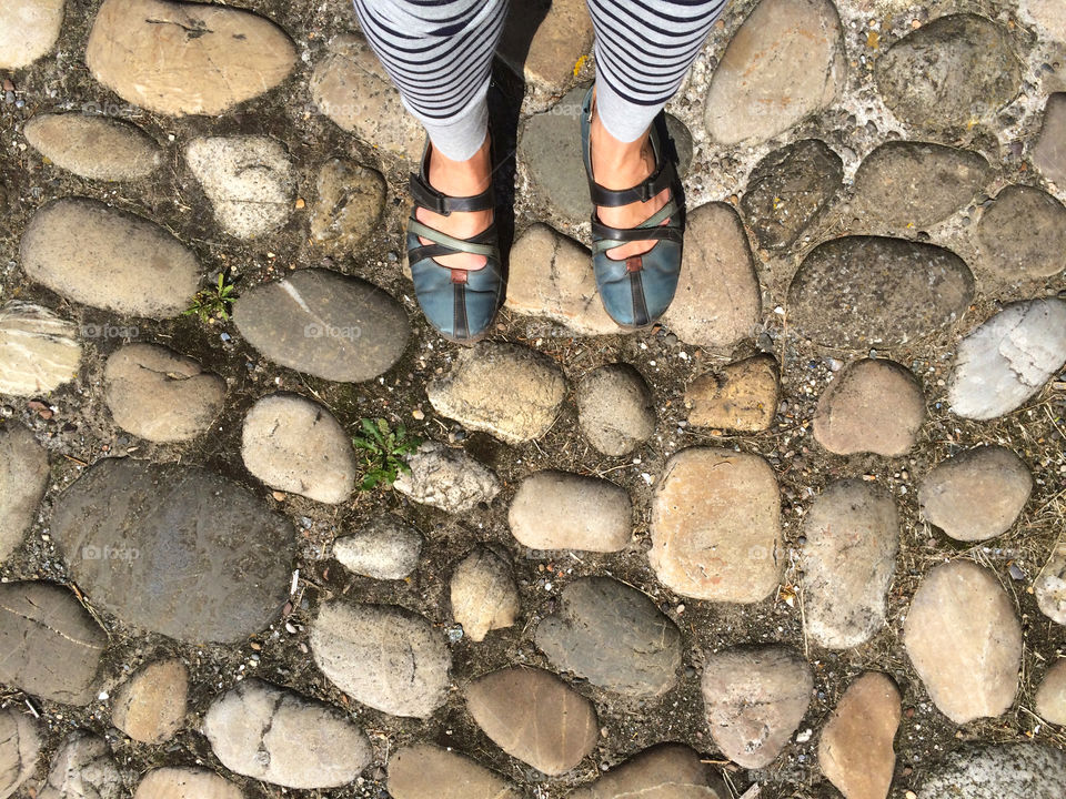 Standing with striped leggings on the sidewalk