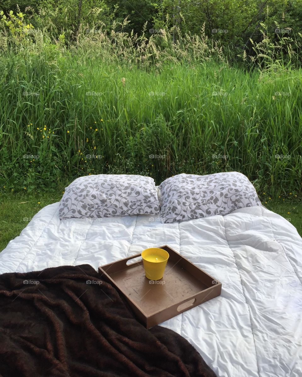 Cozy bed outside for a warm summer evening date