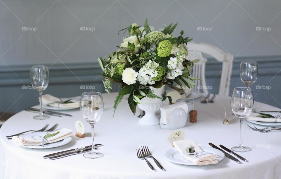 Bouquet of different beautiful flowers in a vase on a festive decorated table