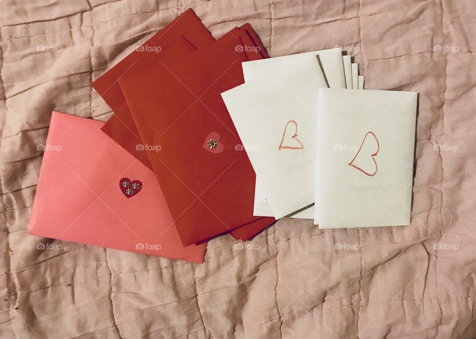 Happy Valentine’s Day card getting ready to send out displayed in Pink, red and white envelopes. USA, America 