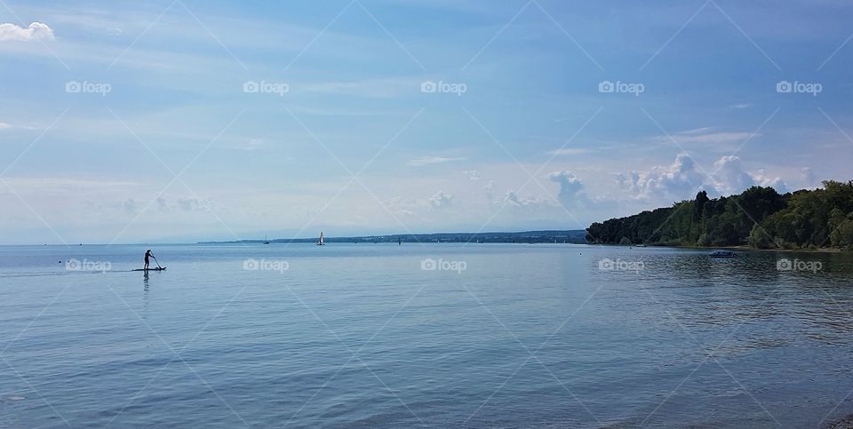 stand up paddling on the blue lake