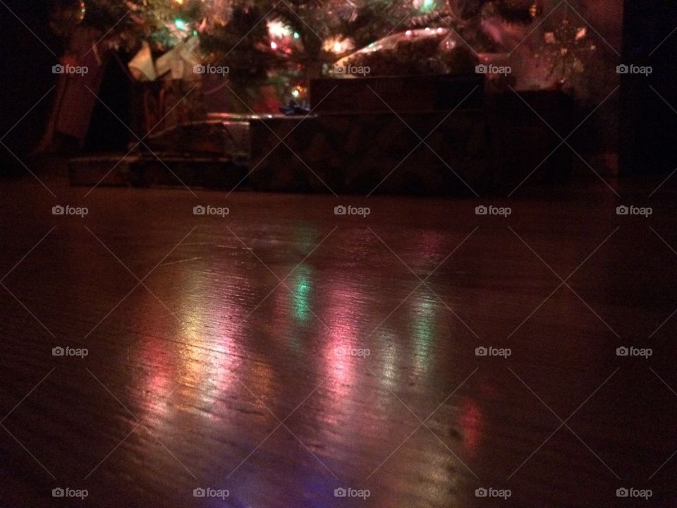 Colourful Christmas lights reflecting on the floor. 
