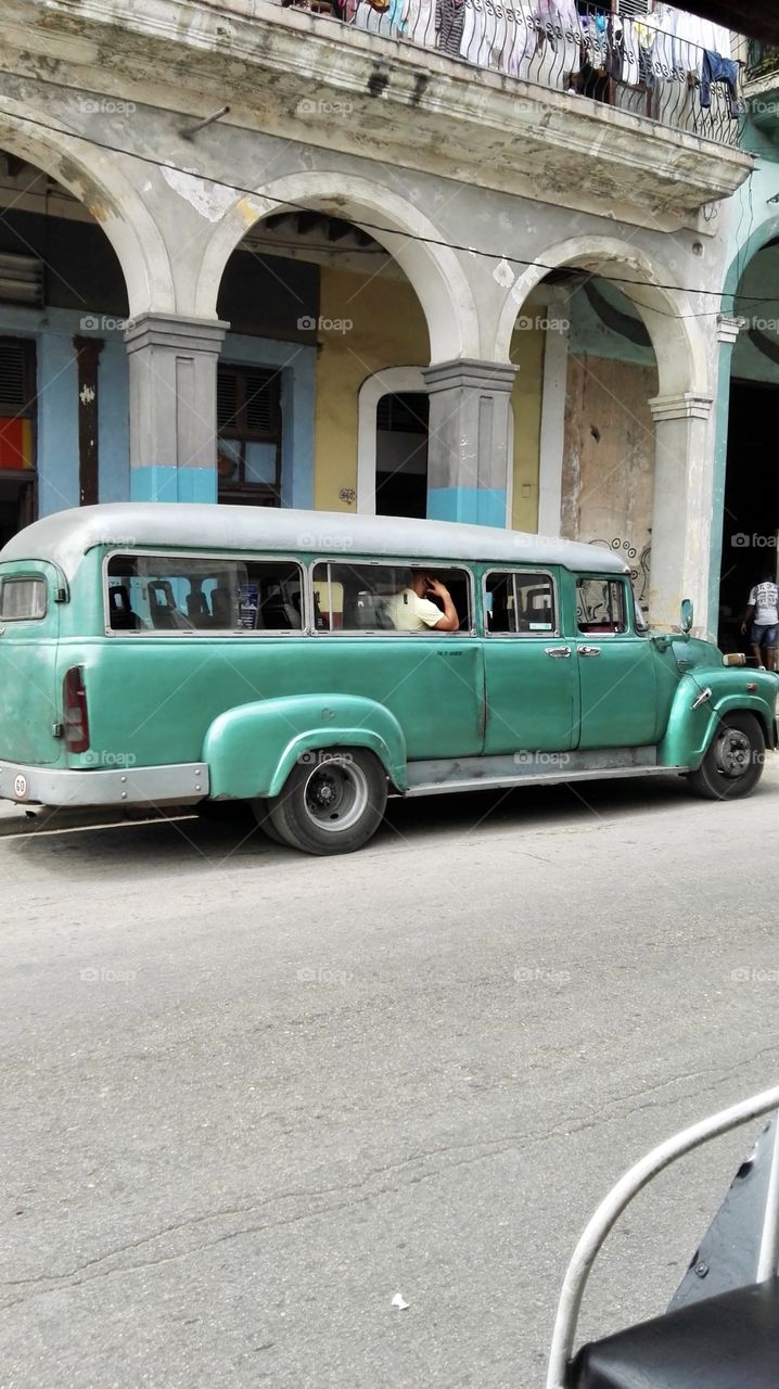 Old green car in the street 