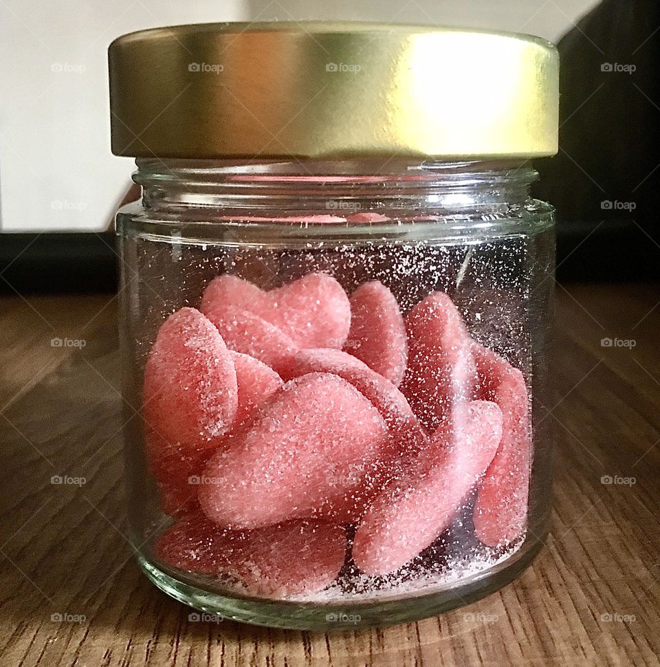 Jar of heart shapes sweets. Glass jar with metal cap