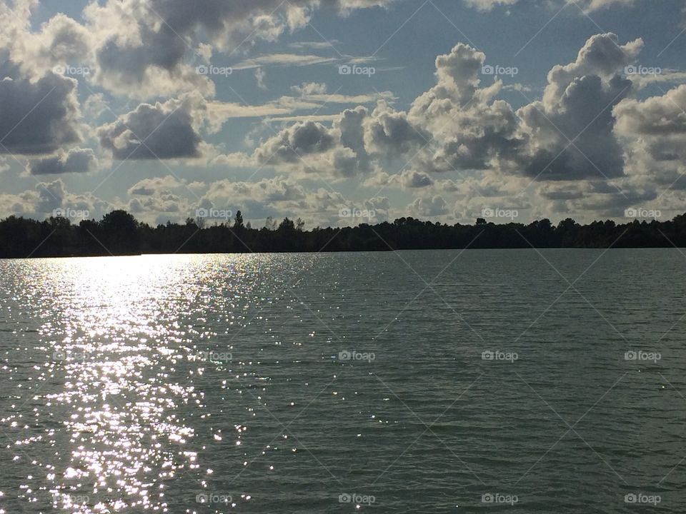 Clouds, sun and lake