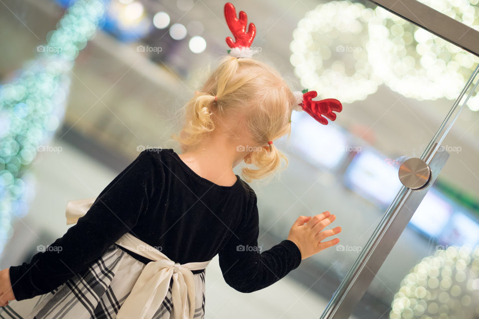 Rear view of a girl wearing antlers