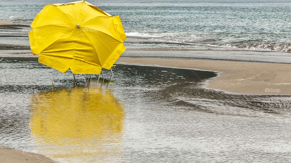 View of a yellow parasol on beach
