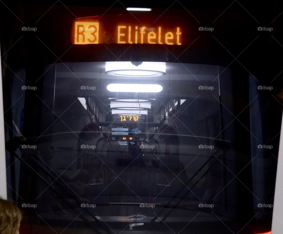 View of light rail  car from the back window in the front rail car