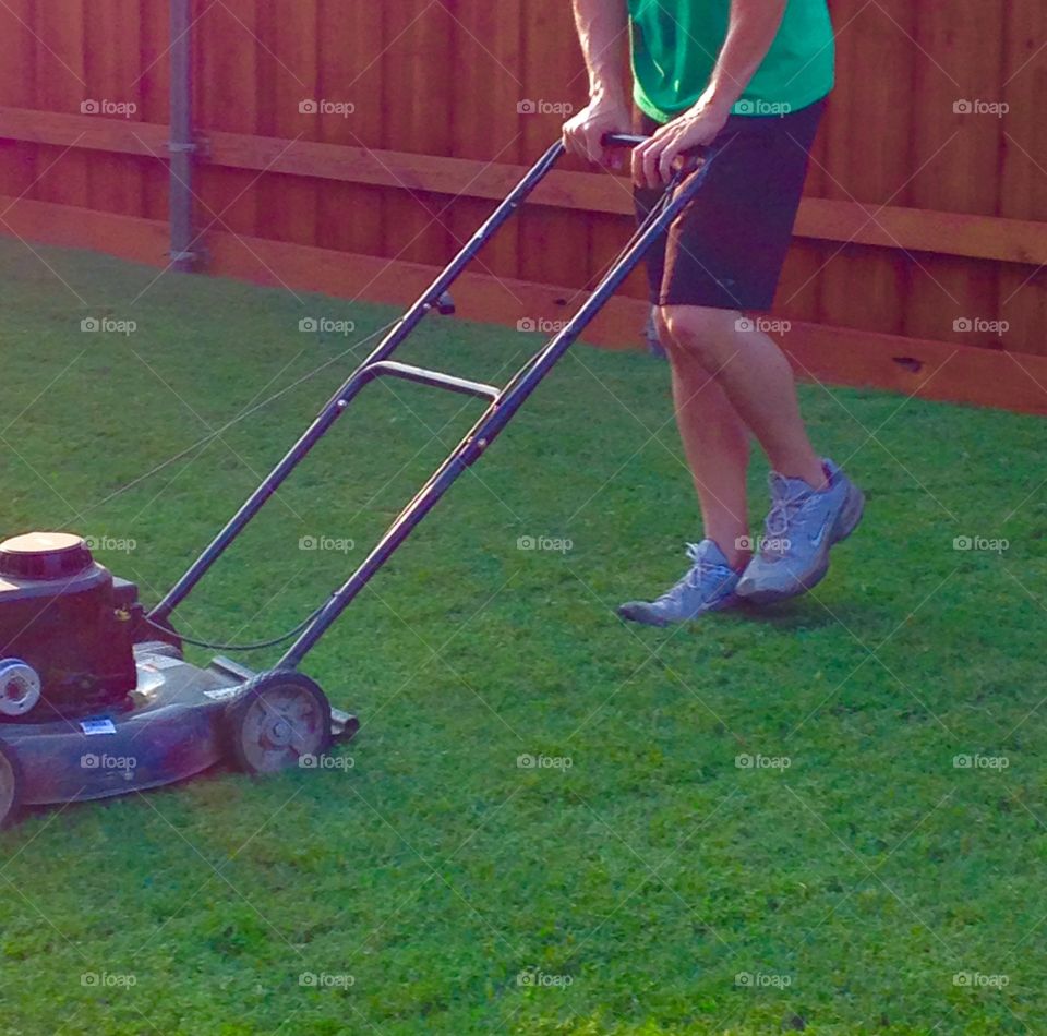 Time to mow. Man mowing backyard 