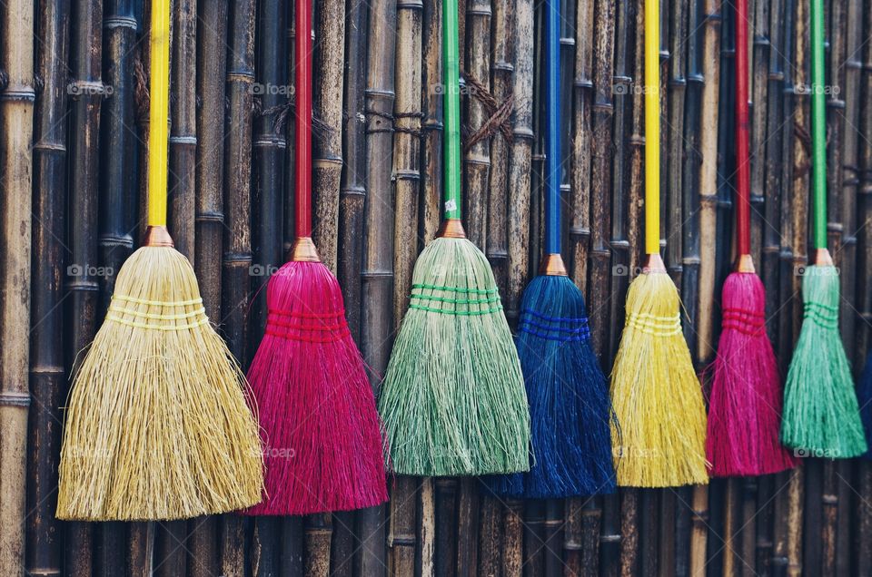 Variety of colorful long handle brooms