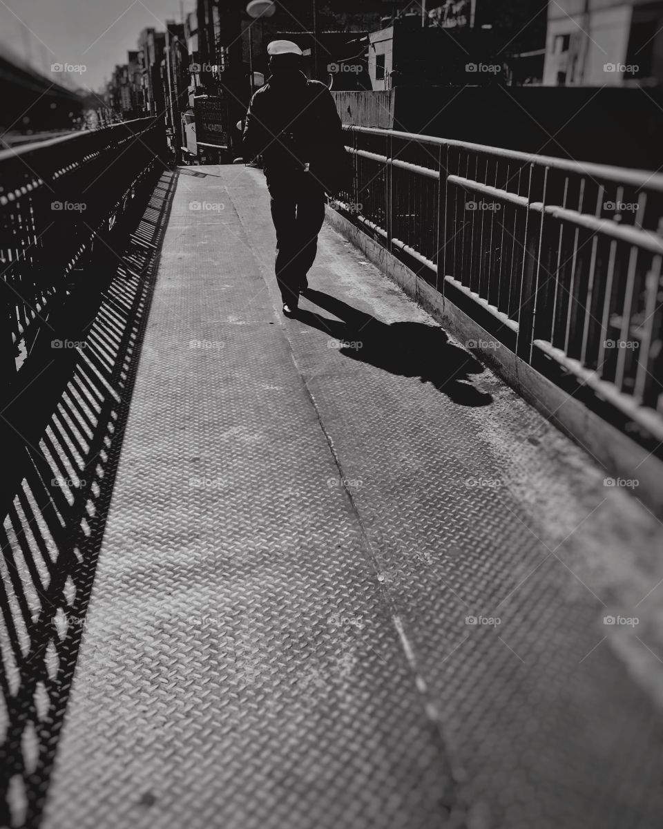 Black and white photography!! A man walking on bridge!
