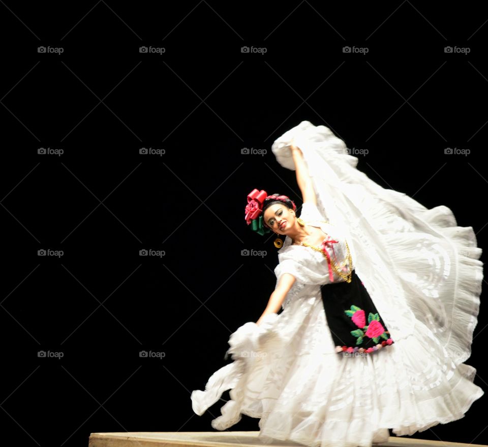 Young woman dancing in traditional dress