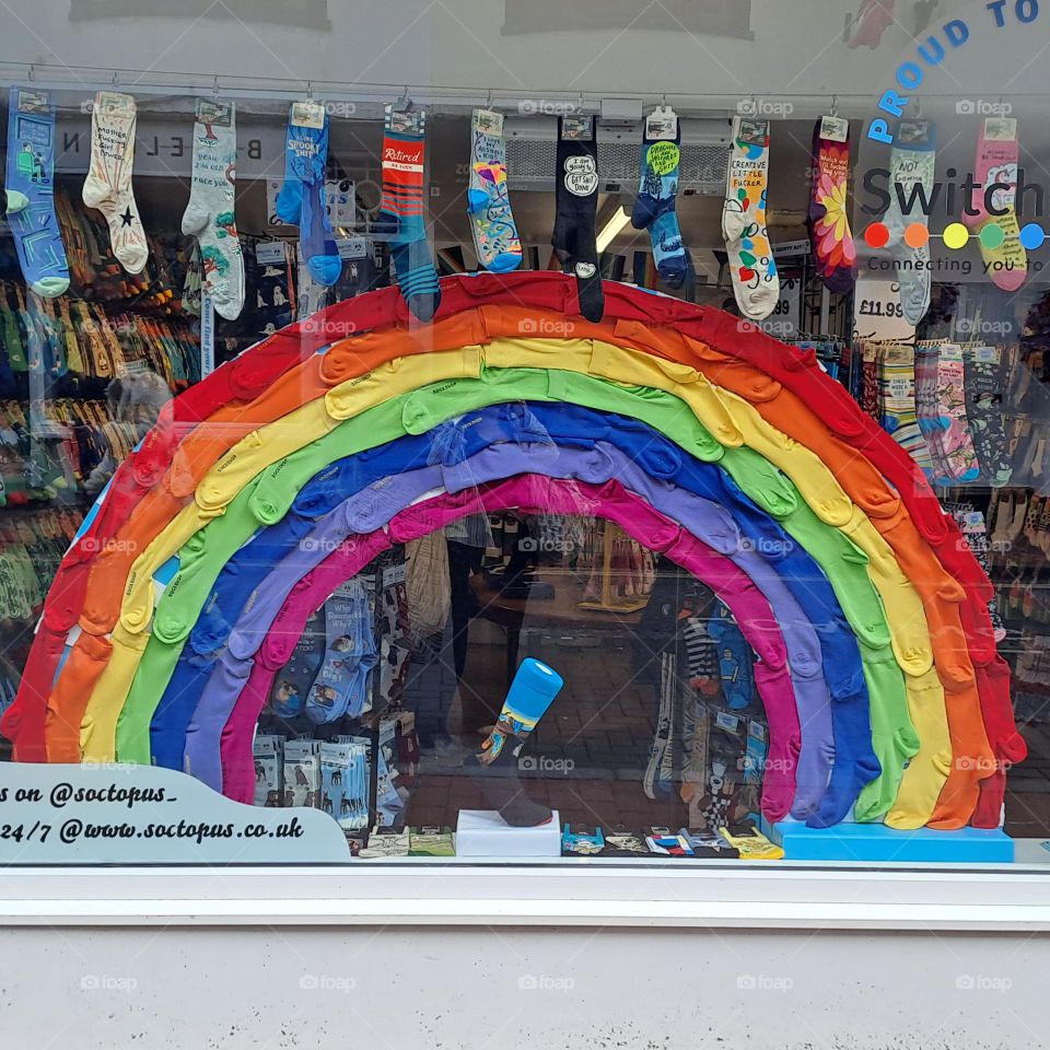 rainbow display. Pride. socks for sale in shop window. colour shopfront