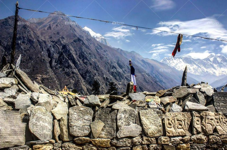A mani wall on the Everest Base Camp Trek. Mt. Everest and Lhotse can be seen to the right.