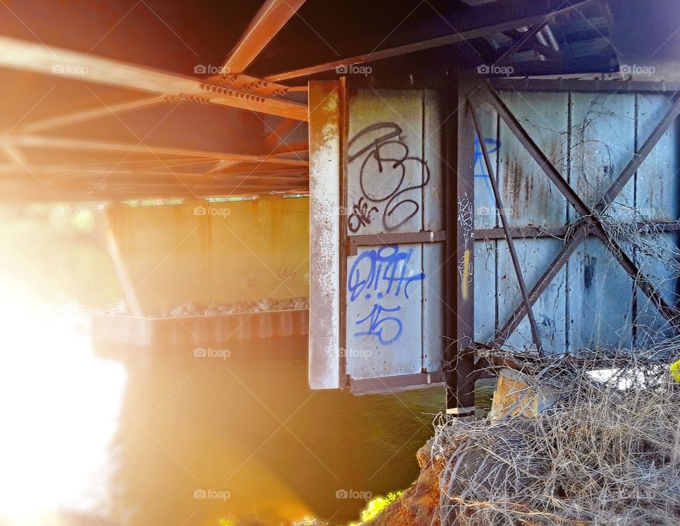 Old billboard under a highway bridge