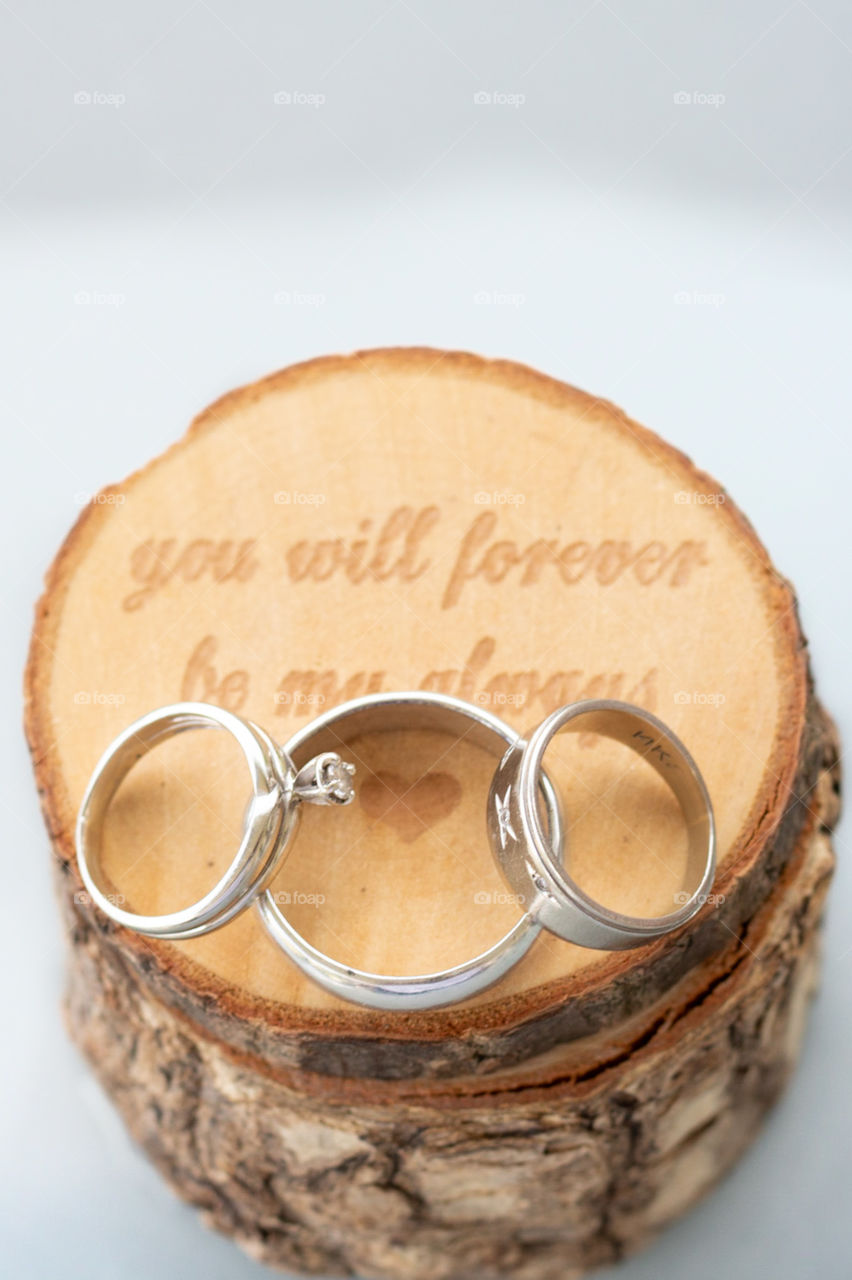 Simple Wedding Ring photo on wooden box with white background.