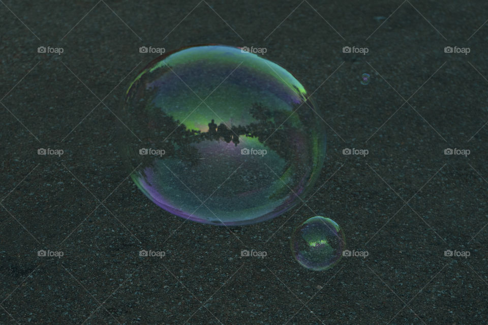 A soap bubble with reflection inside a small kiosk.