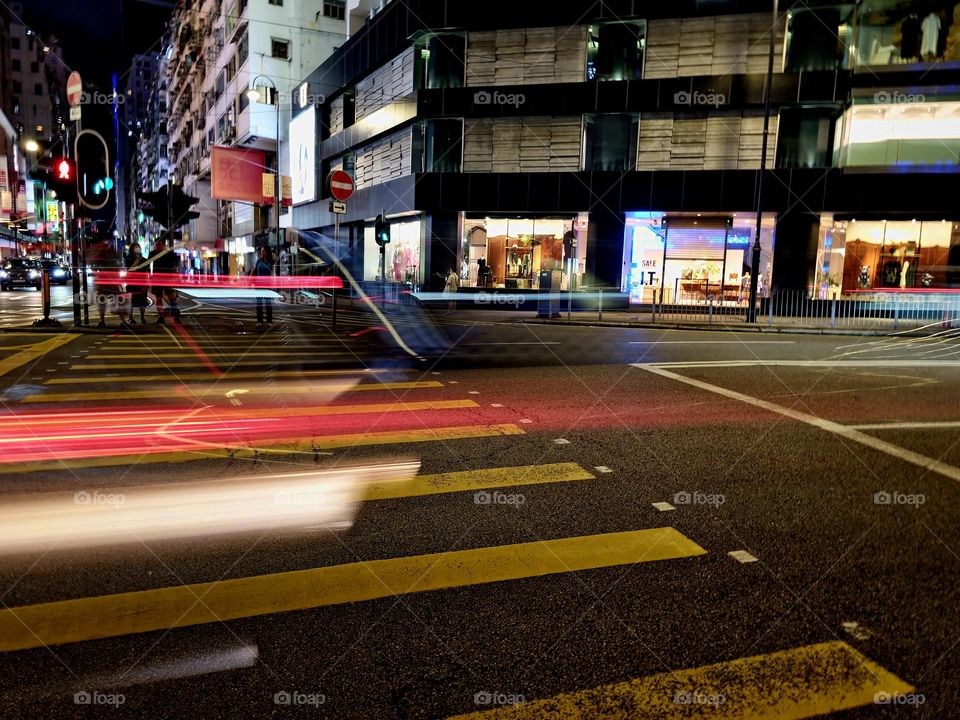 Car in motion on a busy street at night