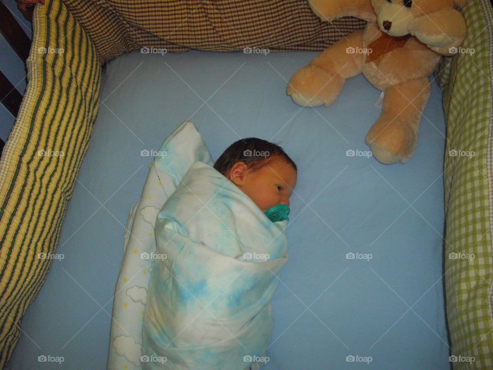 Newborn In A Crib
