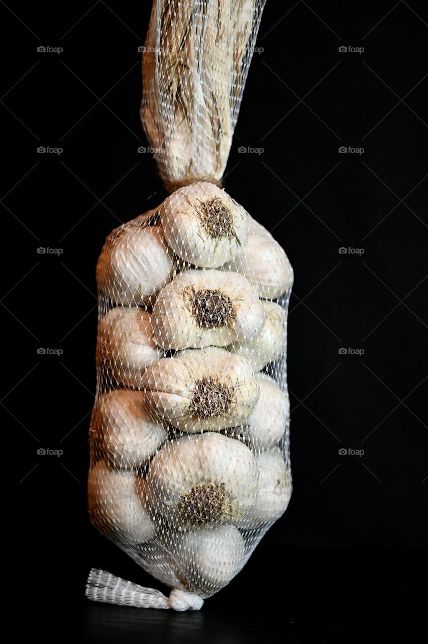 Close up shot of garlic with the black background 