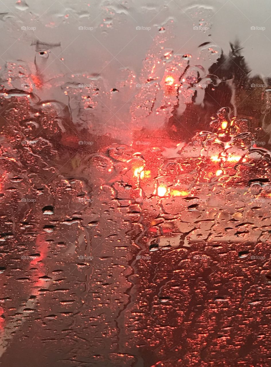Car stopped at a red light in the rain