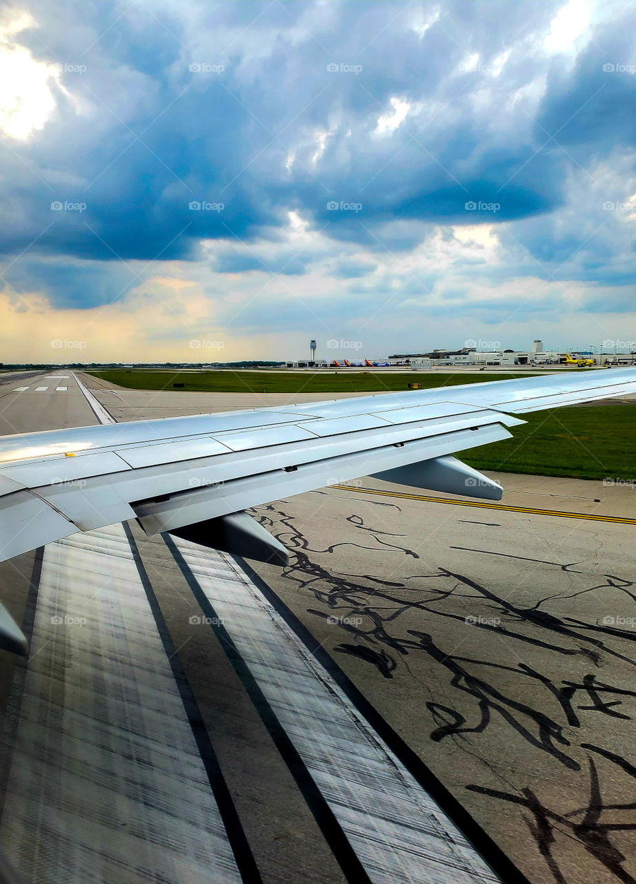 A commercial aircraft turns to begin roll-out and takeoff into threatening skies