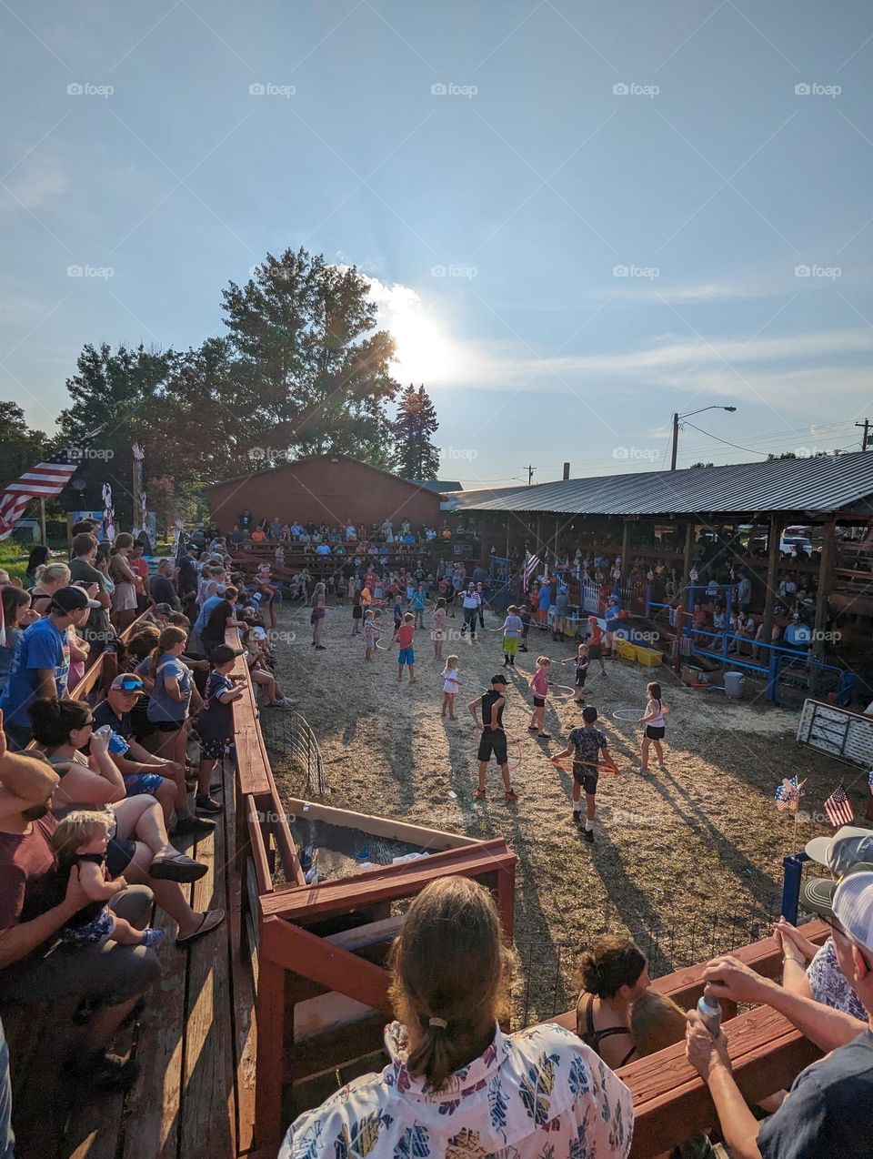 outdoor pig races crowd on a summer evening racing pigs, drinking beer and kids games hoola hooping summer crowd outdoor crowd summer crowd