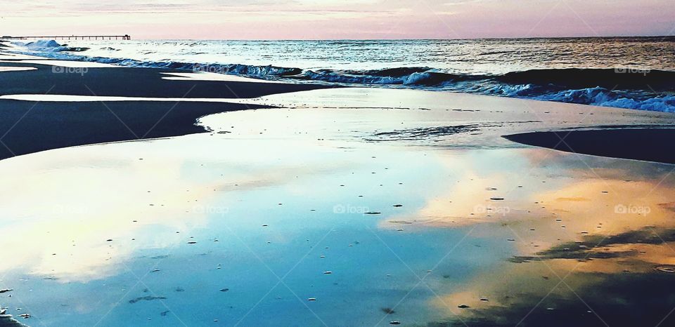 a calm ocean with a blue wave.